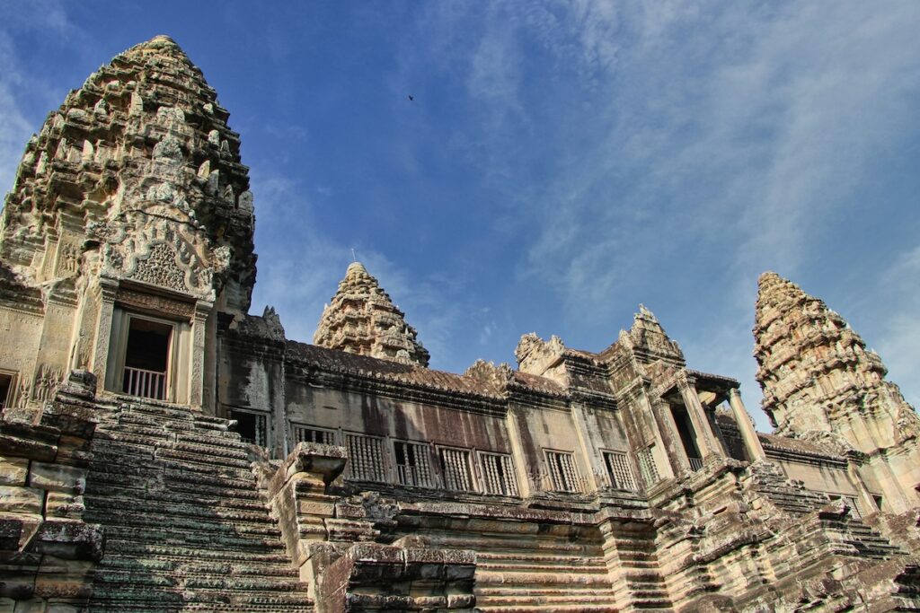 Khmer workers building Angkor Wat with bamboo scaffolding and ramps