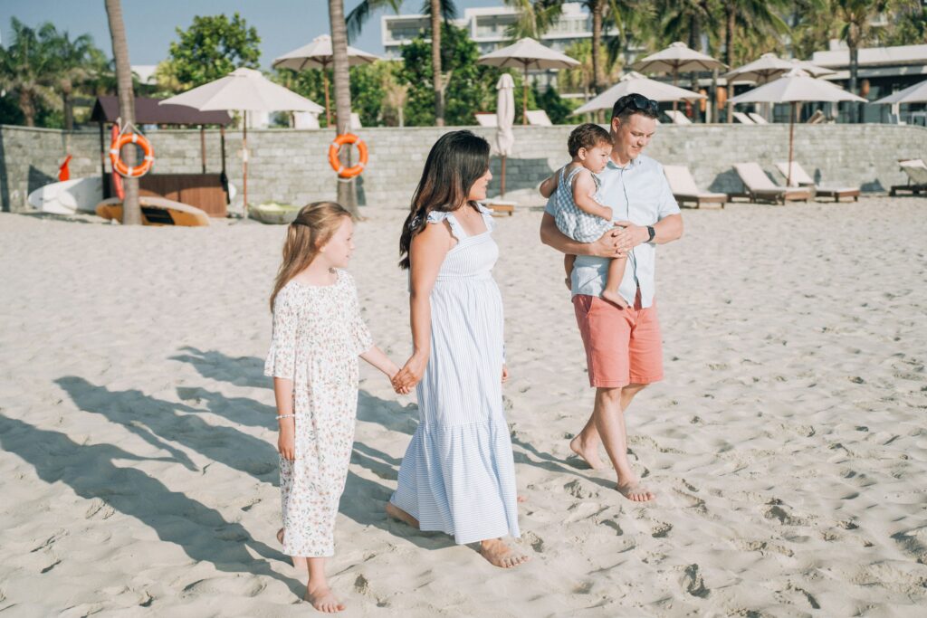 Family enjoying a beach day in the Philippines with kids playing on the sand