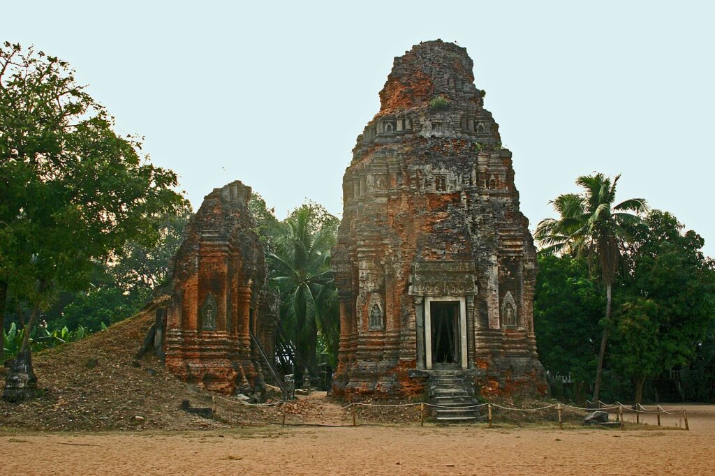 Four brick towers of Lolei temple, surrounded by fields where the baray once was