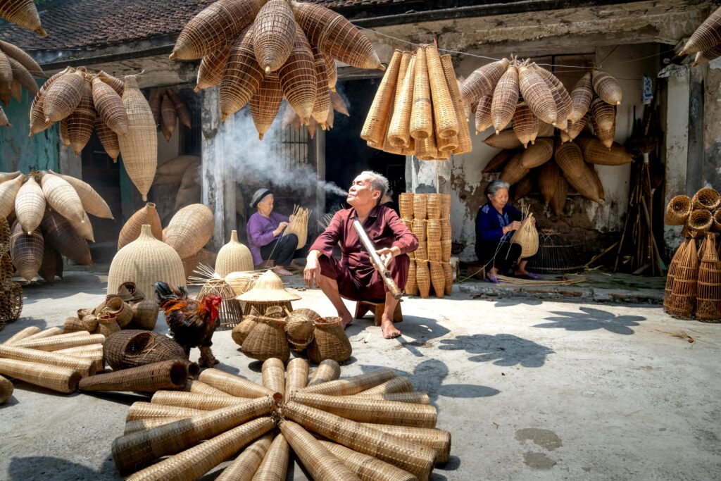 Close-up of hands weaving a bamboo basket in Laos traditional crafts Laos