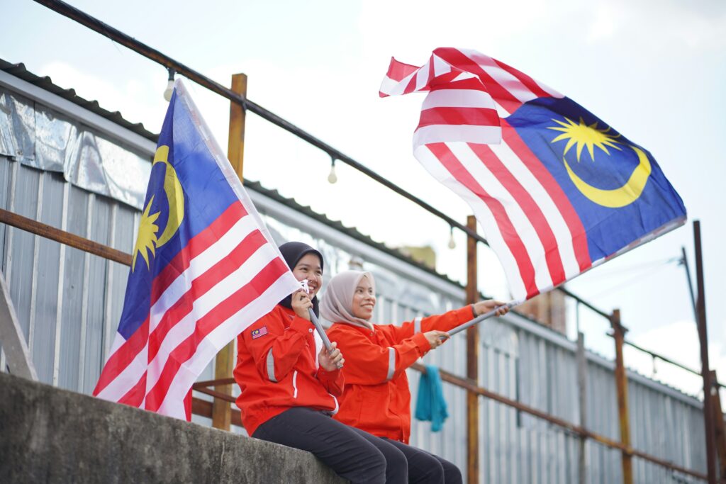 Merdeka Day celebration in Malaysia People celebrating Merdeka Day with flags and national pride