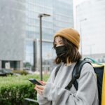 raveler wearing a mask and backpack in a Southeast Asian city