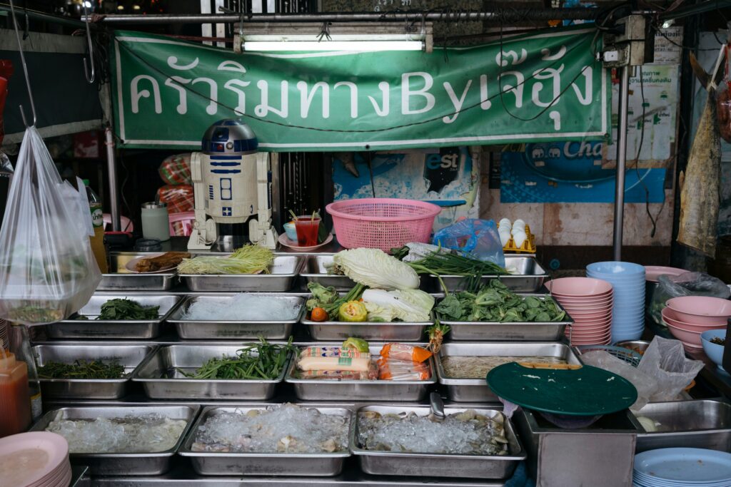 Fresh Ingredients at Bangkok Street Food Stall Street food stall in Bangkok with vegetables, noodles, and seafood