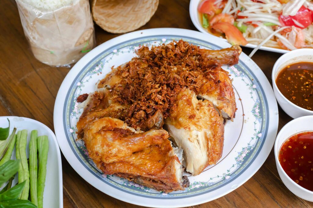 Gai Yang with Sticky Rice and Som Tam – Isaan Street Food Grilled Thai chicken with crispy garlic, sticky rice and papaya salad