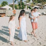 Family enjoying a beach day in the Philippines with kids playing on the sand