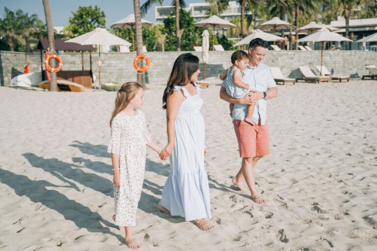 Family enjoying a beach day in the Philippines with kids playing on the sand