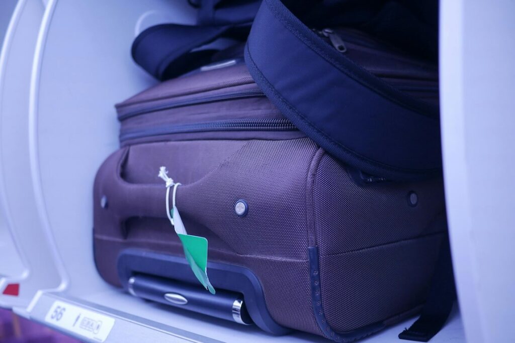 Carry-on baggage in overhead bin on a flight in Southeast Asia  