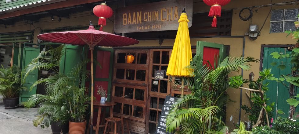 Cozy coffee shop in Talat Noi Bangkok with red lanterns and colorful umbrellas