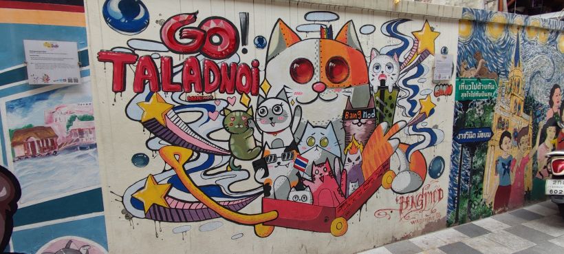 Talat Noi Bangkok street art with cat graffiti on narrow alley wall